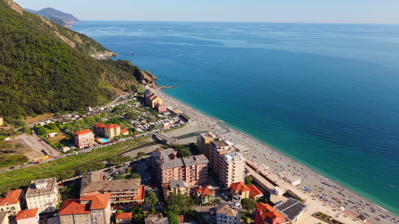 Beautiful coastal town in Italy with buildings, beach, and the sea on a sunny day
