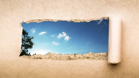 creative 4k time laps video of fast moving clouds in the blue sky that are visible through a hole with torn edges in old retro grunge vintage paper.