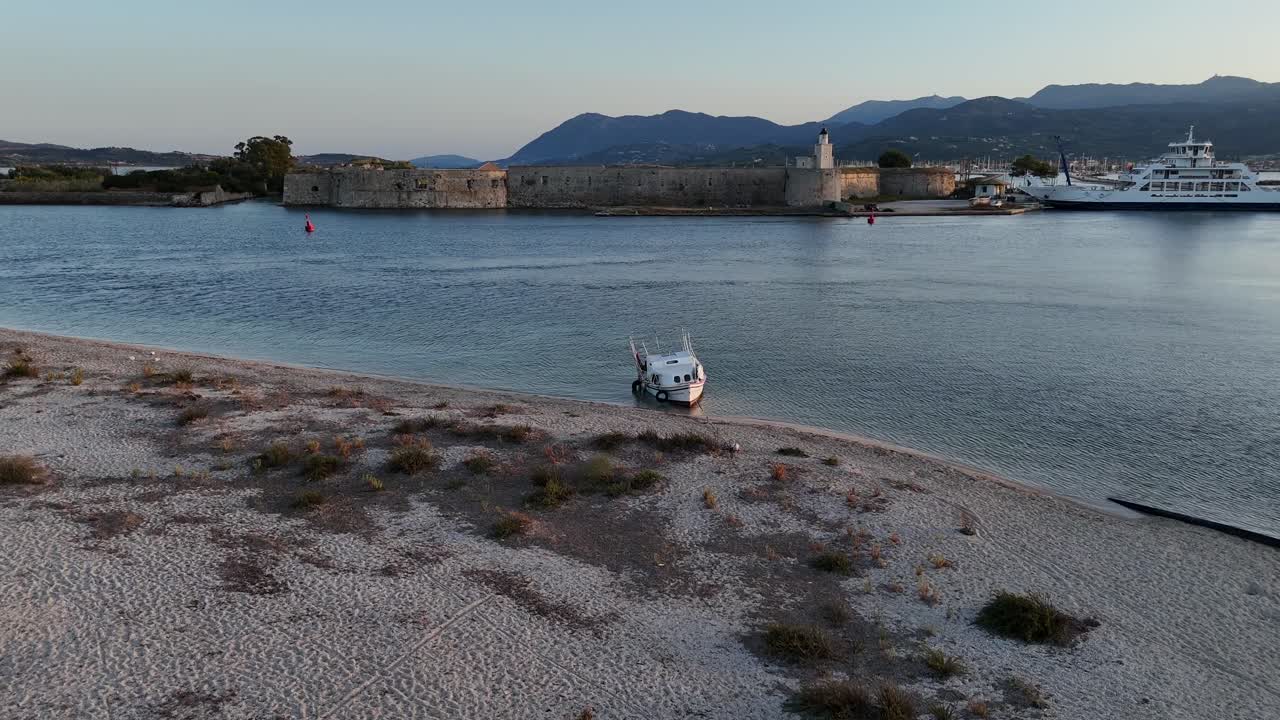 Lefkada Island,Aerial view forward towards the famous landmark medieval Venetian Castle Agia Mavra Fort with ancient stone walls.Ferry bridge is by the castle