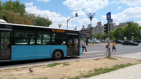 blue bus at a city intersection