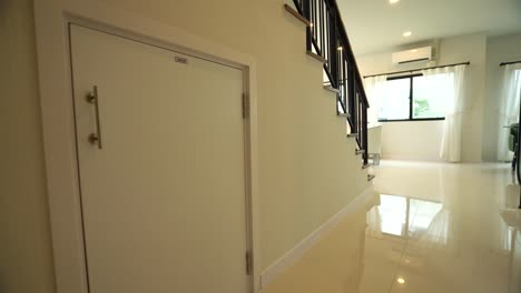 Built-in-Under-Stairs-Storage-Room-in-White-Modern-House,-Close-Up