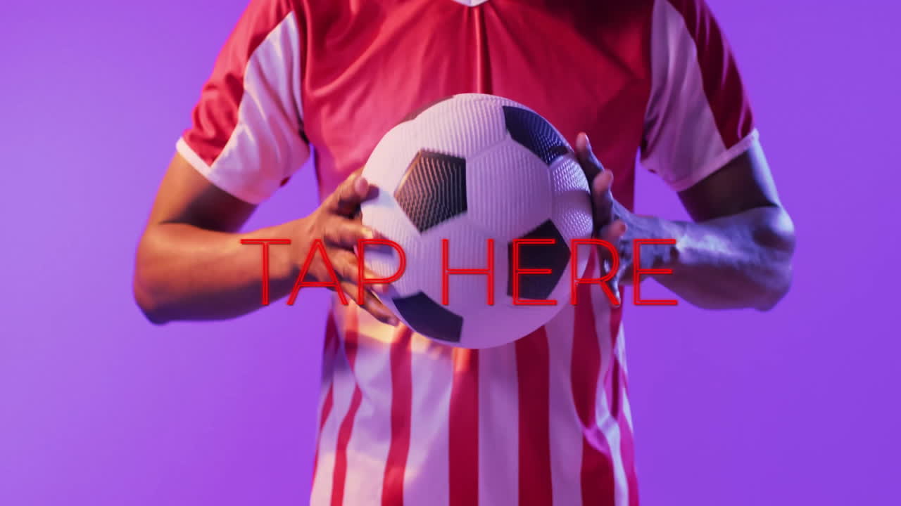 Holding soccer ball, animation of Tap Here text on purple background