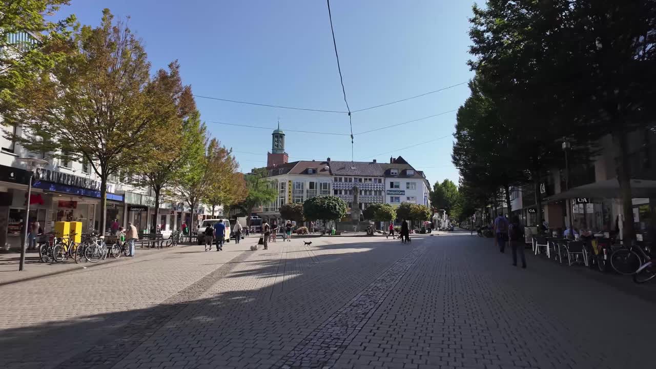Darmstadt street walking with people and bicycles, towards Ludwigsplatz square. Hessen, Germany