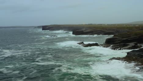 aerial pan of rough atlantic ocean and loop head peninsula at bridges of ross
