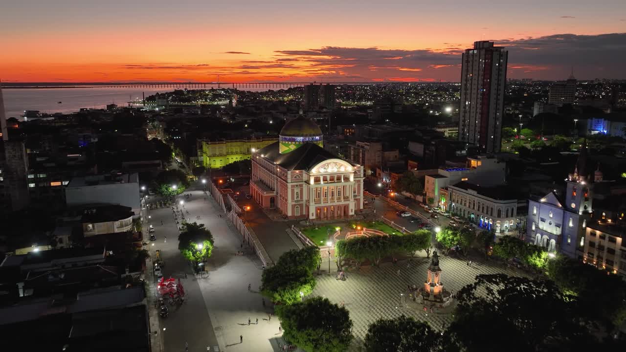 Colorful sunset sky over medieval building at cityscape downtown Manaus Brazil near Amazon river and Amazon Forest. Travel destinations. Sunset skyline. Sunset coastal city at Manaus Brazil.