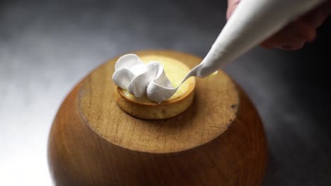 decorating a small lemon tart with sweet snow foam