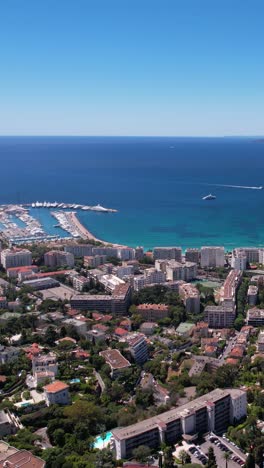 vertical drone shot of cannes france, seafront marina, buildings and yachts