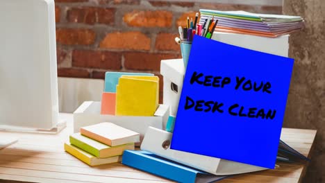 animation of keep your desk clean text on memo note over stationery items on desk