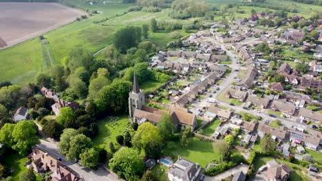 aerial video flying towards a church in a village in kent, uk