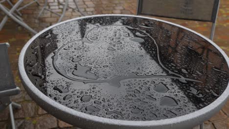 romantic woman draw heart shape on wet glass of small table