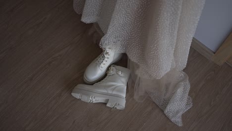 bride in delicate gown paired with stylish white boots, blending elegance and edge