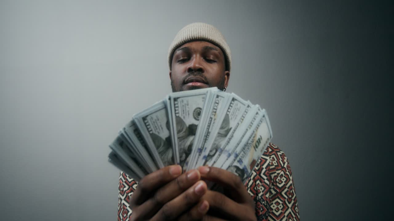 Man Holding US Dollars