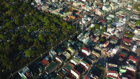 aerial: olympia, south cemetery and the santa cruz barangay, sunny afternoon in makati, philippines