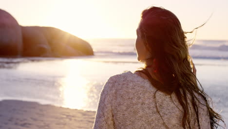 portrait of beautiful girl smiling on beach at sunset in slow motion