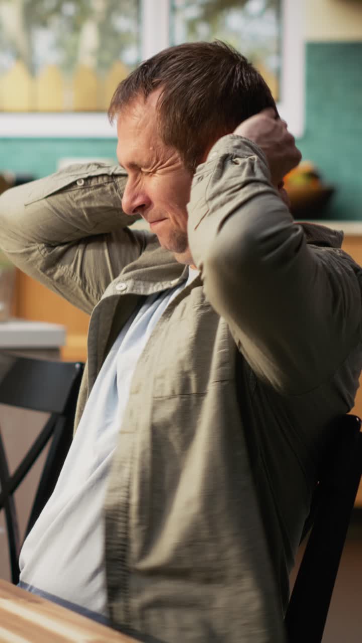 Vertical Video Smiling dad on tablet multitasking and chatting with his pre-teen daughter