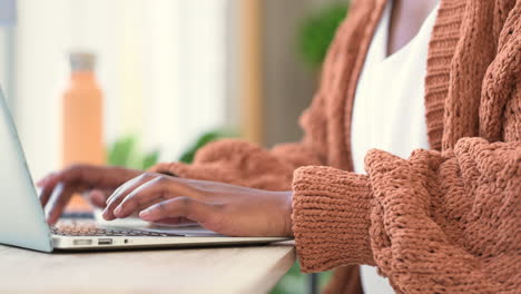 journalist student typing a report on a laptop