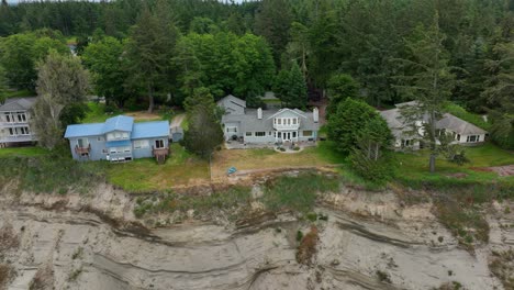 Aerial-shot-of-houses-on-top-of-an-eroding-cliffside