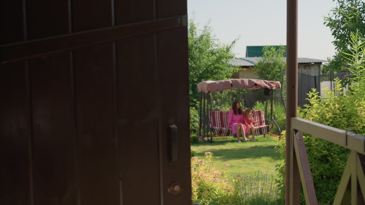 Porch Garden Scene, Quiet Backyard With Swing And Woman, Serene Scene Featuring Woman And Swinging Seat Outdoors, Peaceful Scene Where Woman Relaxes On Swing In Her Backyard During Afternoon