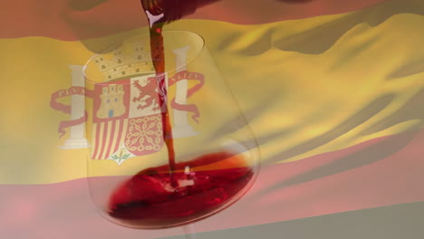composite of red wine being poured into glass over flag of spain background