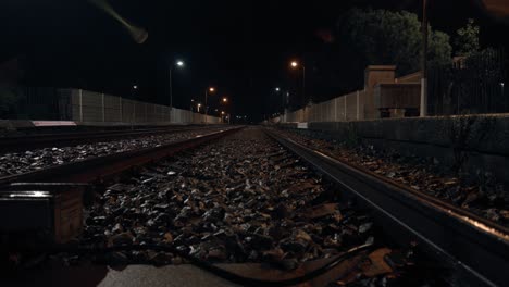 railroad track with crushed stone ballast sleeper at night