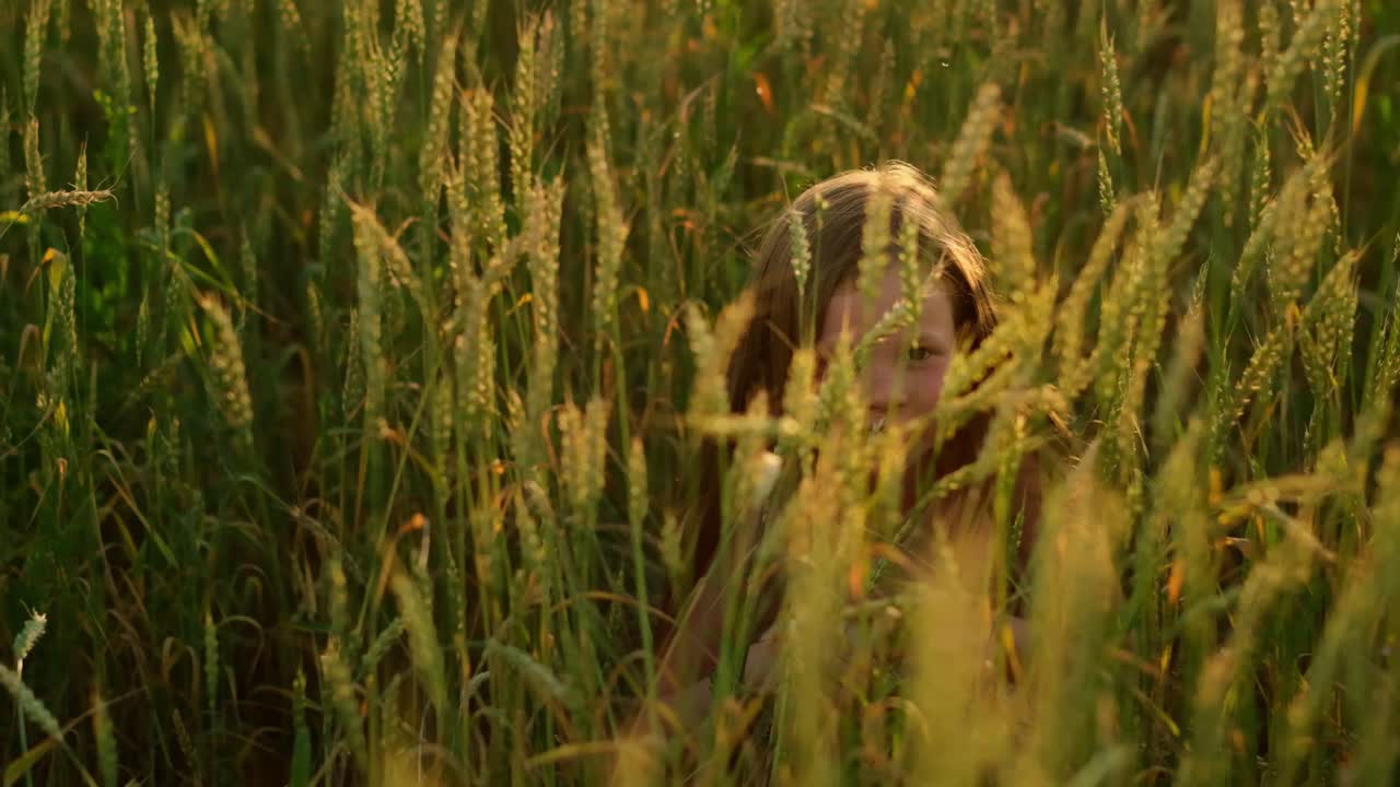 Girl Hiding in a Wheat Field at Sunset