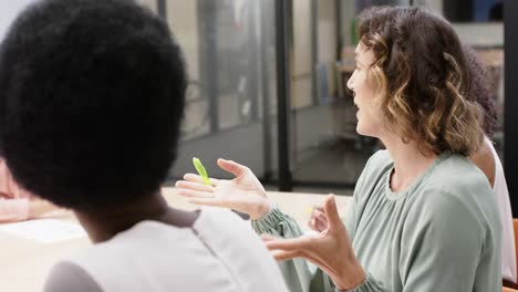 Happy-diverse-businesswomen-discussing-work-at-office-meeting,-in-slow-motion