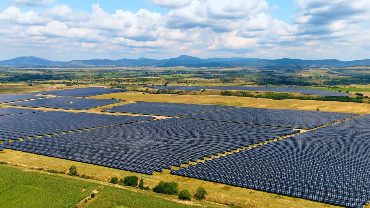 Vast fields of solar panels in the vast countryside. Sustainable energy produced in the rural area. Aerial view