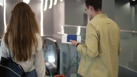 Rare-View-Of-Family-With-Yellow-Stylish-Suitcase-Going-Down-By-The-Escalator-With-Their-Pretty-Daughter-Hold-By-Mothers-Hand-At-The-Airport