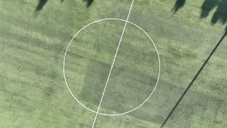 aerial footage of taking off from a soccer field while spinning