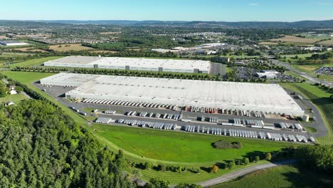 huge warehouse with hundreds of semi truck trailers for distribution and goods in america