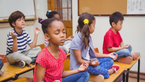 animation of schoolchildren sitting meditating in school classroom