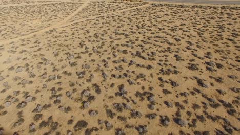 Aerial-tilt-up-over-a-lonely-desert-community-in-the-Mojave-Desert-of-California--1