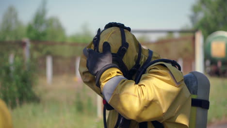 person putting on protective hazmat suit