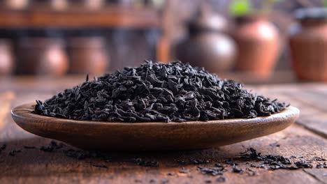 black tea leaves in a wooden bowl