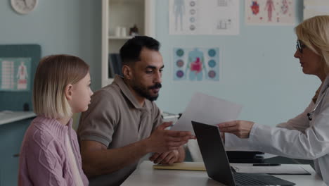 a family consulting with a doctor in a clinic