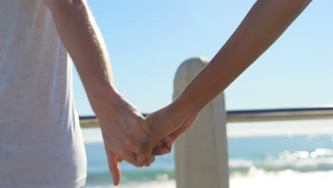 close-up of couple running hand in hand on the promenade 4k