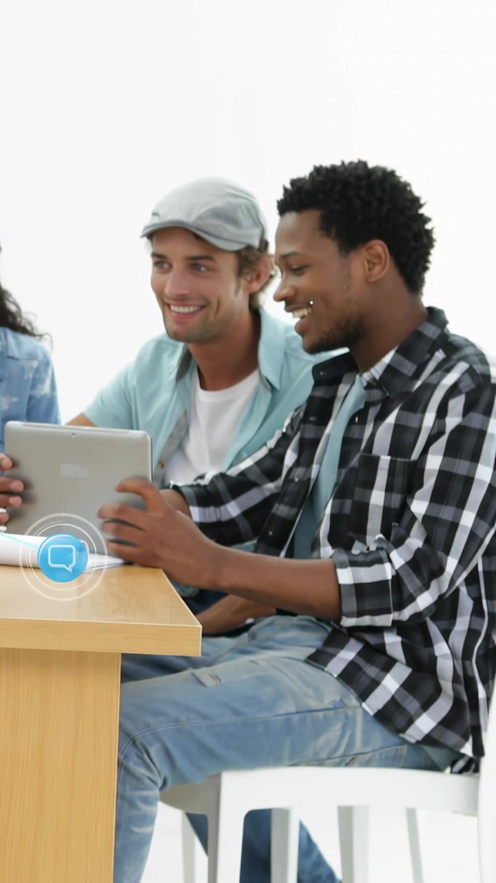 Vertical video: Two men tapping tablet causing icons and chats expanding over scene for education