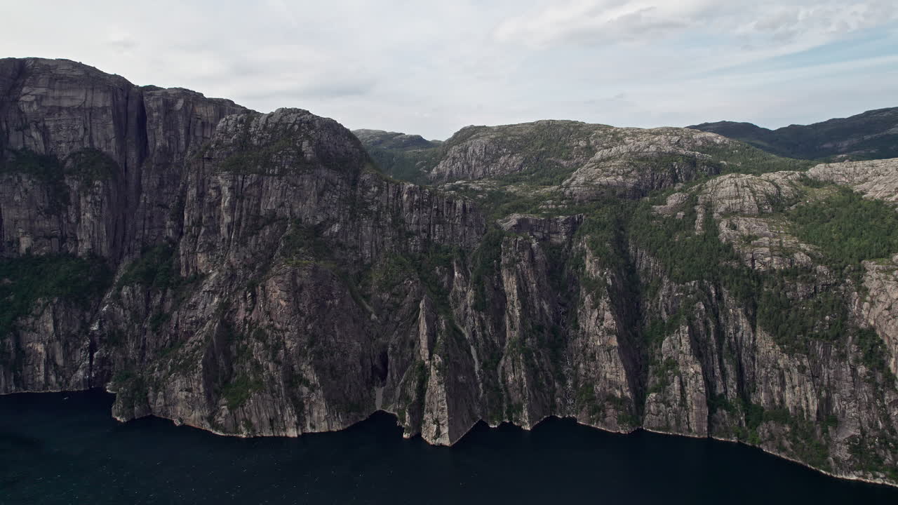 Fixed aerial shot of the cliffs beneath Preikestolen, by Lysefjord in Norway