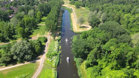 aerial drone shot above a nature park, water canal with boats, of almere city, province flevoland, netherlands