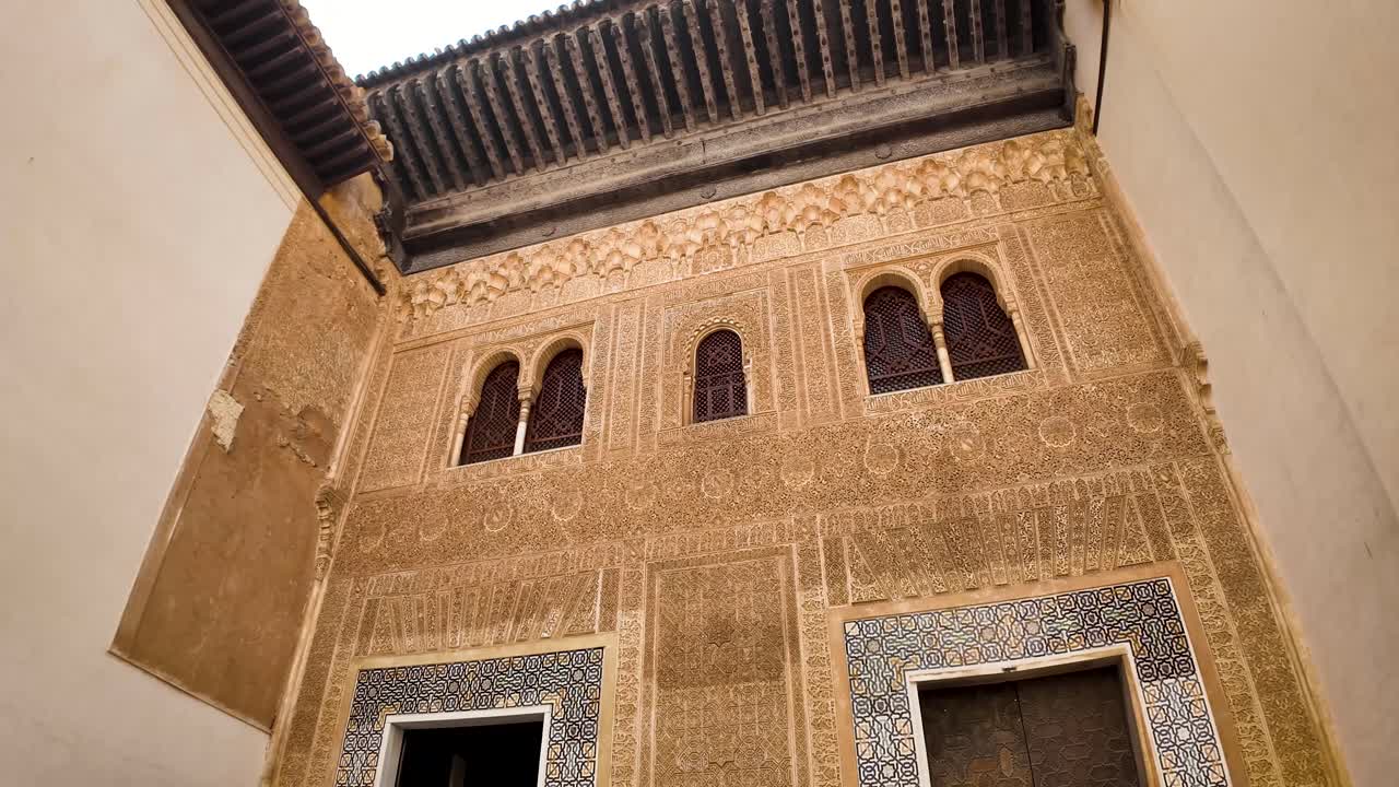 Panoramic and detail shot of the Comares facade facing the gallery of the Golden Room, marking the division between the public and private areas of the Alhambra monumental complex in Granada, Spain