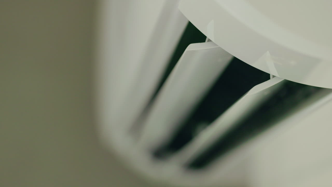 Close-up of a white wall-mounted air conditioner vent