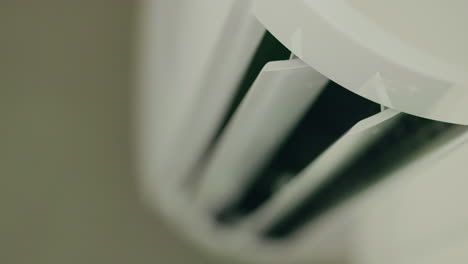 close-up of a white wall-mounted air conditioner vent