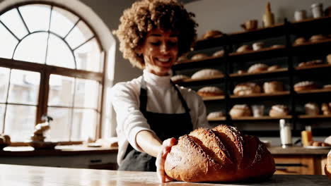 woman baker displaying freshly baked bread