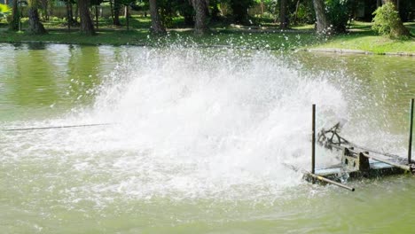 el aerador de rueda de paleta activo en el estanque para aumentar la disolución de oxígeno en el agua en el parque. las turbinas de agua están trabajando para ayudar a evitar que el agua se pudra.