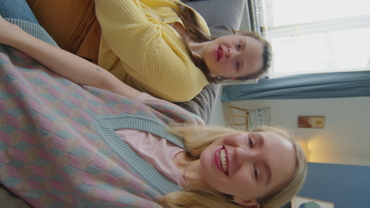 Girl with Down Syndrome and Woman Waving and Smiling on Camera