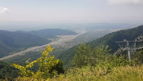 gondola lift moving above qebele city azerbaijan on sunny summer day, tufandag mountain resort