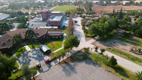 Drone-fly-above-green-parked-area-of-Santiago-de-Chile-suburbs-Lo-Prado-station