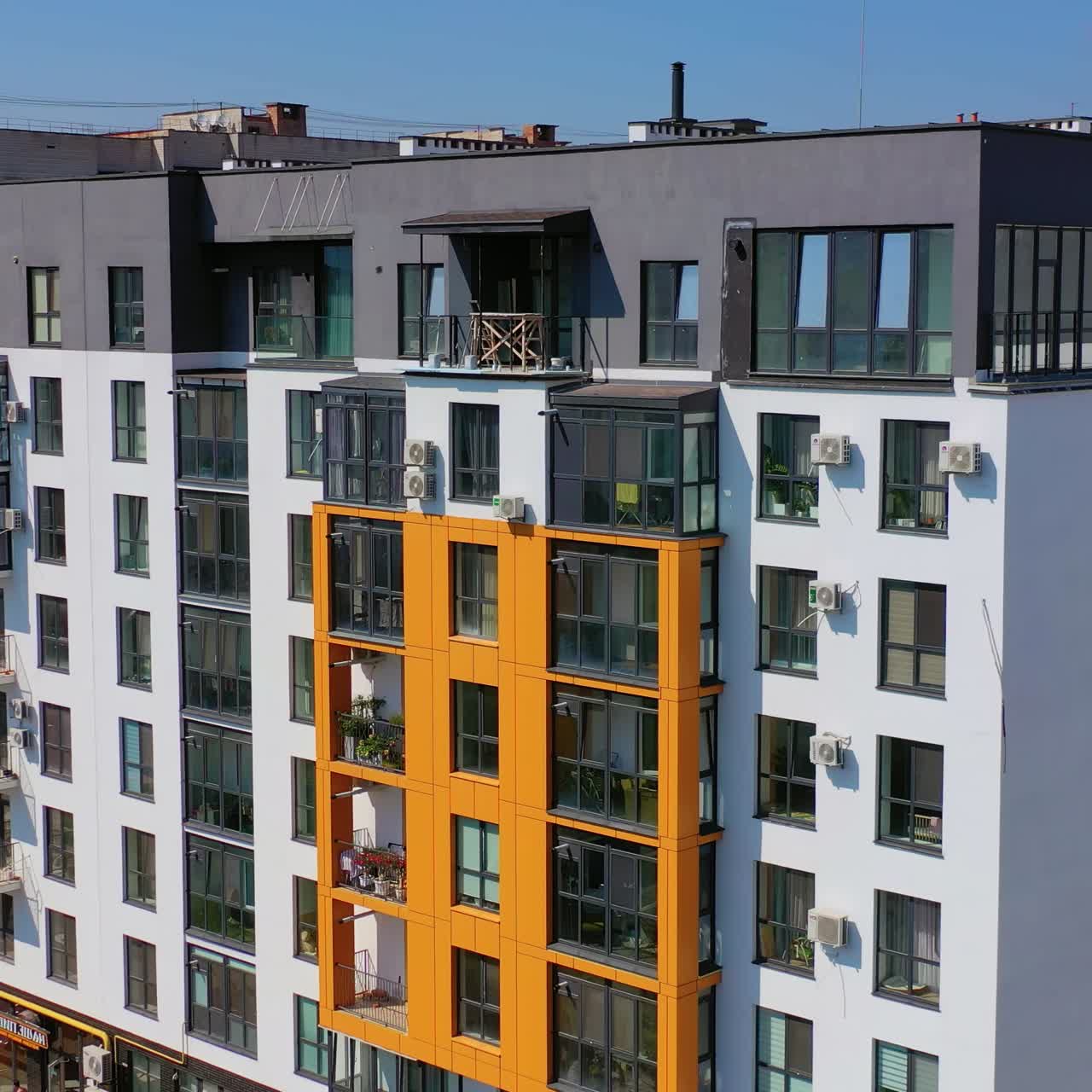 Contemporary residential building in the city. Exterior of a modern design of multistorey apartment building. Aerial view.