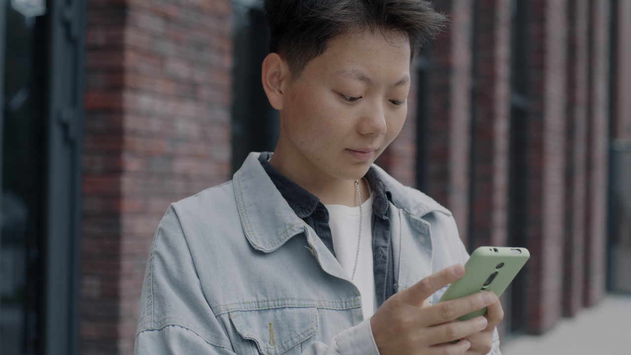 Young Person Using Smartphone Outdoors