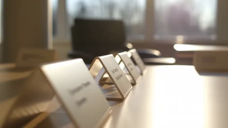 Empty Conference Room Table with Name Tents Bathed in Sunlight